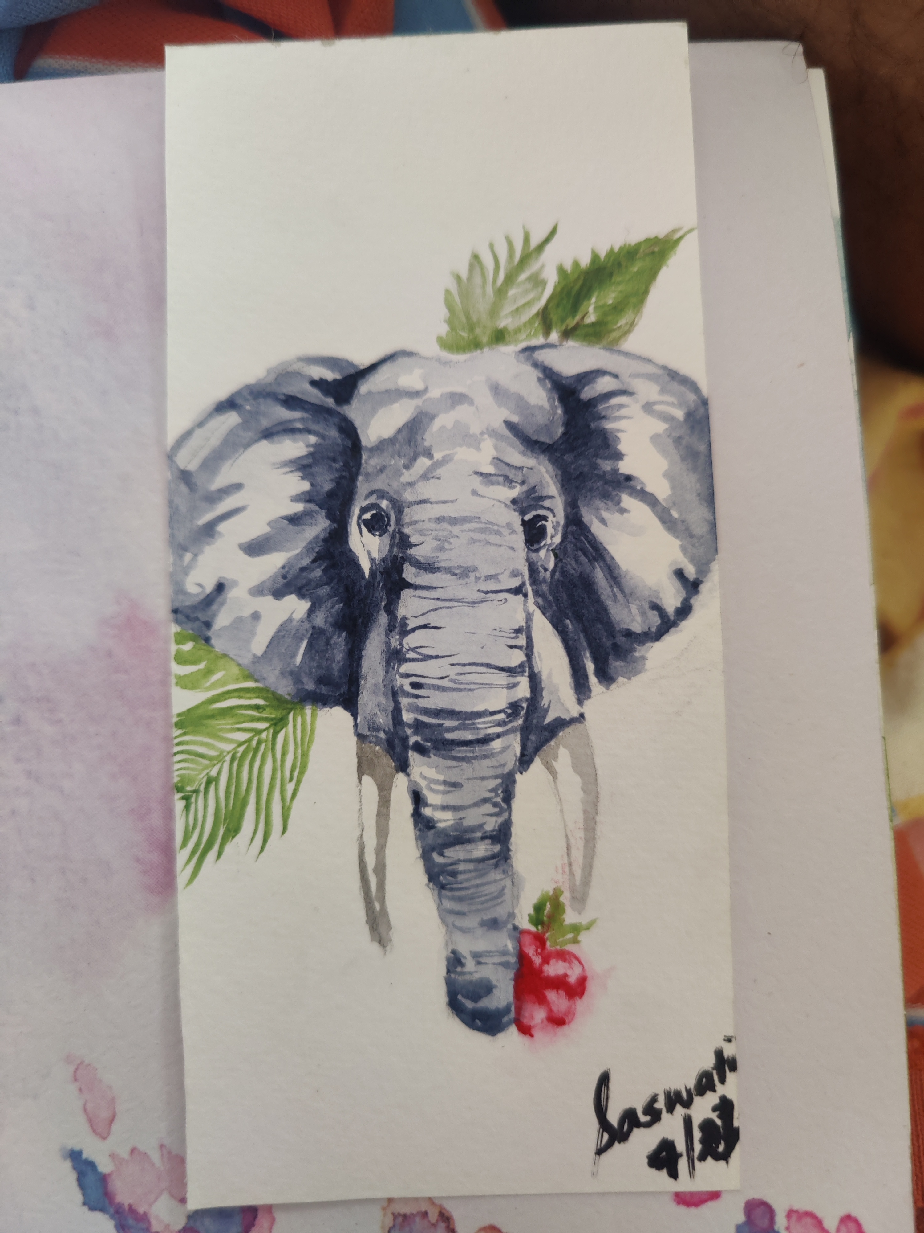 Watercolor painting of an elephant with tropical leaves, signed Saswati
